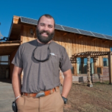 Jared "Cappie" Capp stands in front of his energy-independent house on Friday morning in Spearfish. Capp has created a house that generates its own electricity, and uses various building methods and materials to make the house entirely self sustaining.